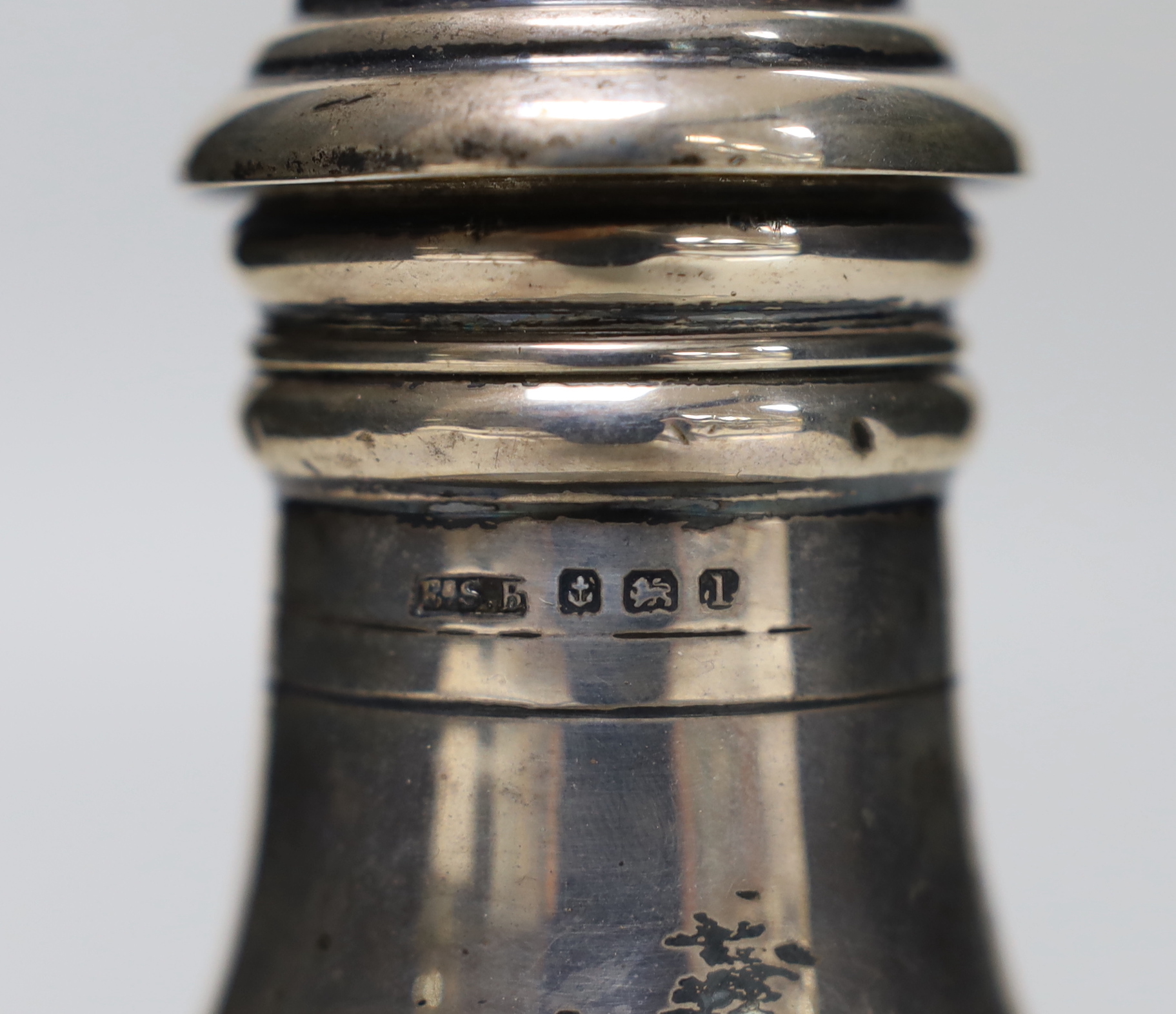 A George V silver baluster sugar caster, E.S. Barnsley & Co, Birmingham, 1910, 13.9cm, a silver salt and a sterling condiment, 5.5oz.